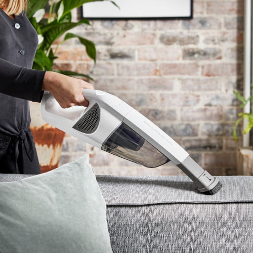 closeup woman using cordless vacuum cleaner